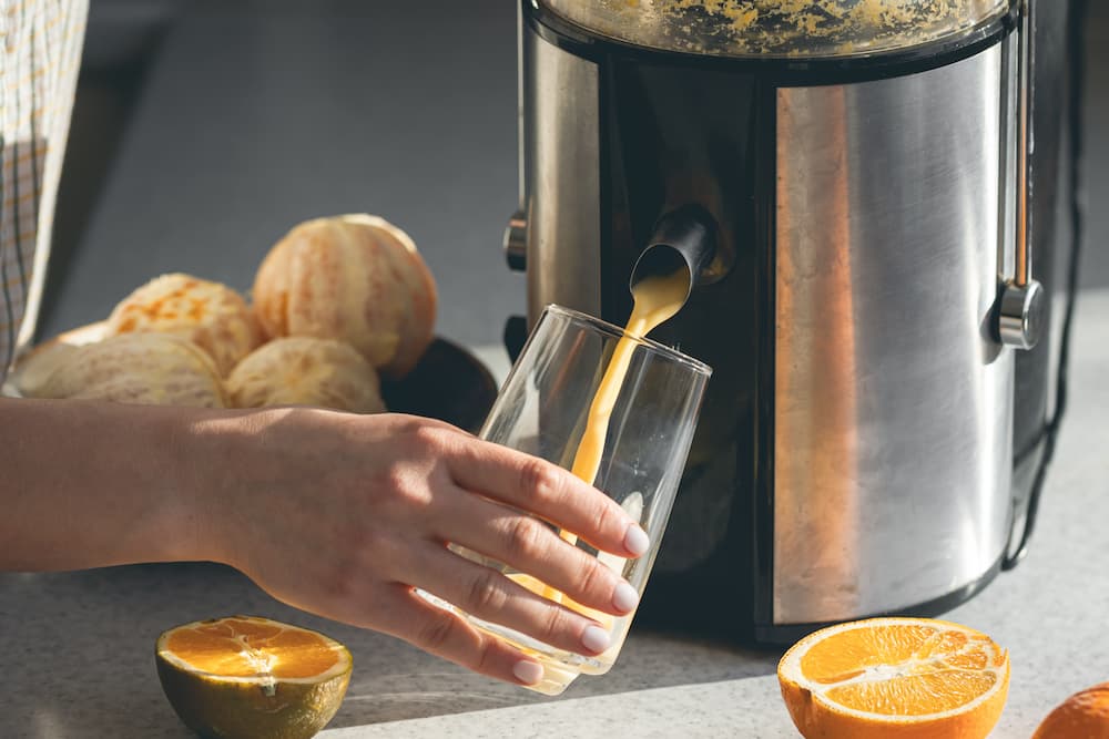 Juicer juicing an orange
